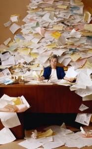 woman at paper clutter desk
